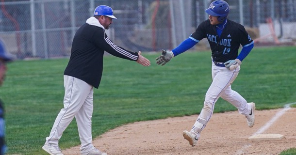 Sophomore Cory Wouters rounds third base after hitting his 20th home run of the year, congratulated by Coach Jon Olsen. Wouters set a school RBI record with 94 and leads the MCC offense into the Region IX post-season tournament starting Thursday.