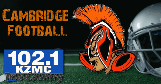 Football field in the background with the Cambridge Mascot on the right, the words Cambridge football on the upper left corner and the KZMC-FM 102.1 logo on the bottom right.